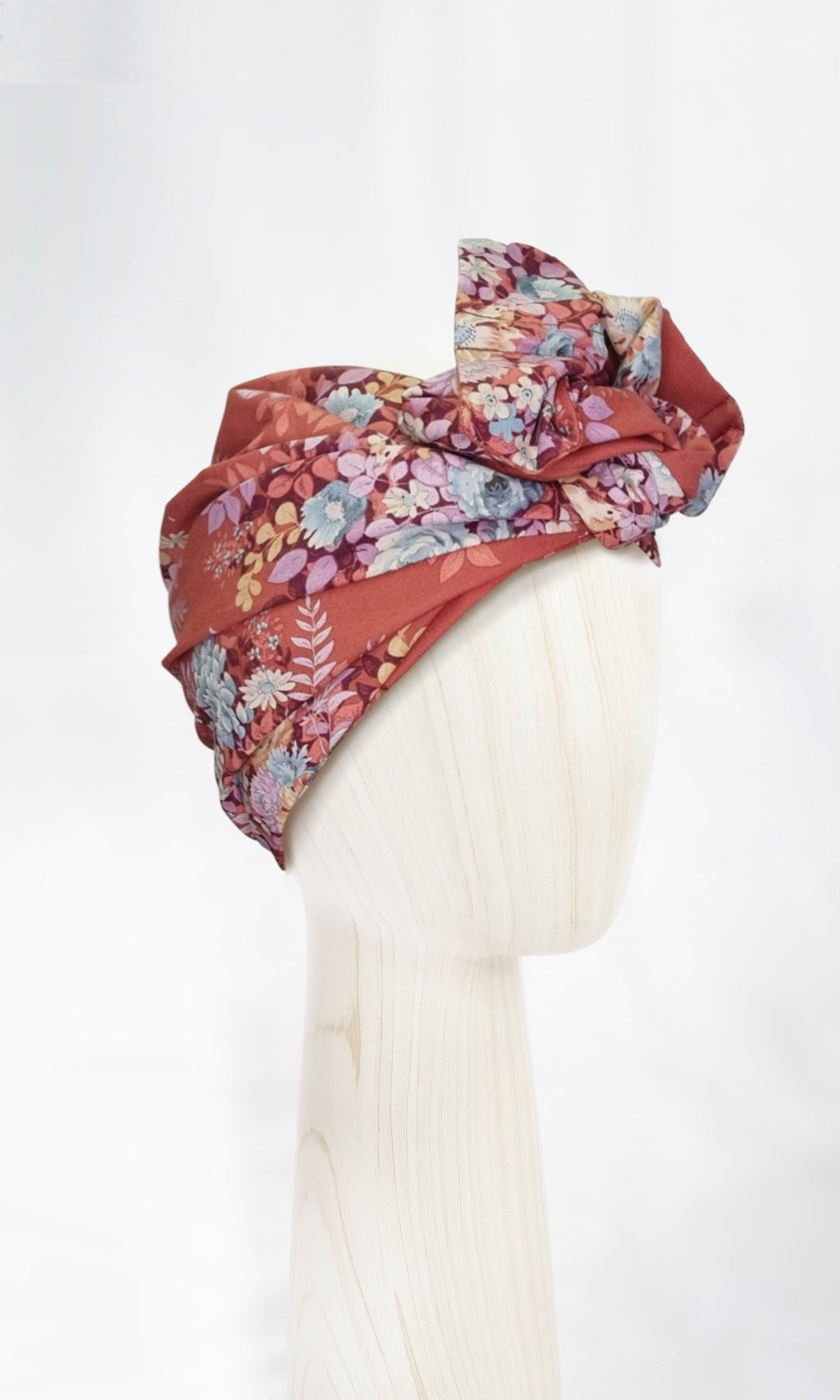 The Celine Martine wired head wrap in whimsyflower rust displayed on a mannequin head styled in one of several hair scarf options