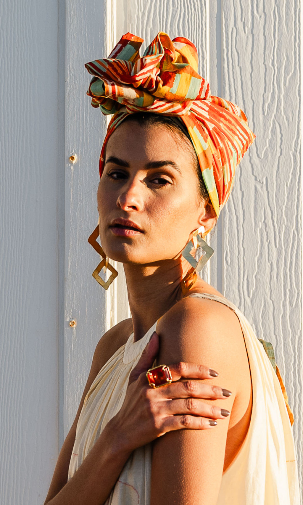 Model wearing Celine Martine’s Josephine Wired Head Wrap in Ember vibrant brushstroke print, styled in a top knot