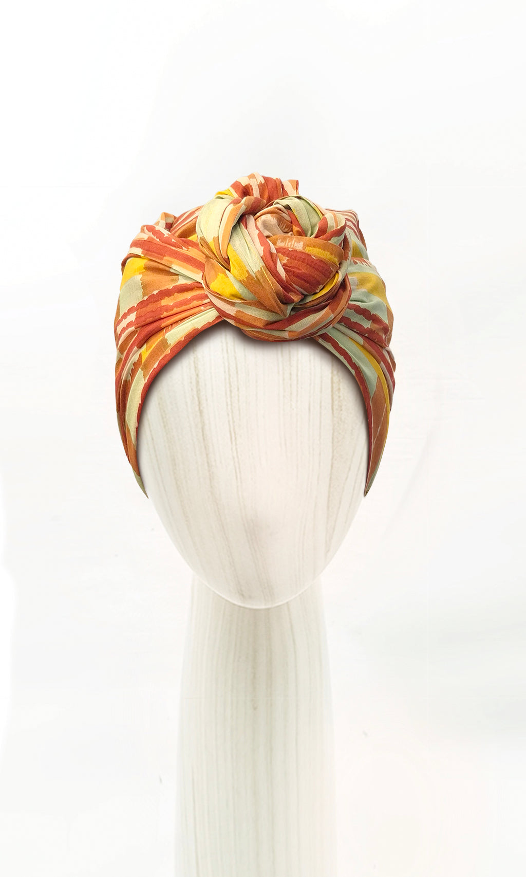 Celine Martine Josephine Wired Head Wrap styled in a front twist, with vibrant brushstroke stripes in tangerine, saffron, rust and aqua