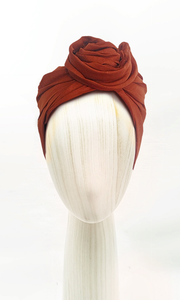 Celine Martine Jospehine Head Wrap in Rust styled in rosette knot on mannequin – versatile cotton-linen blend with removable wire