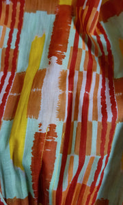 The Josephine Wired Head Wrap fabric by Celine Martine, shown in Ember print with sculptable form and rich hues of rust, saffron, and aqua