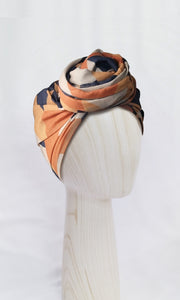 Celine Martine Josephine Geo Nautic with extra-length head wrap in cotton-linen fabric, styled with a central front knot. Features signature geometric pattern and offers endless styling options.