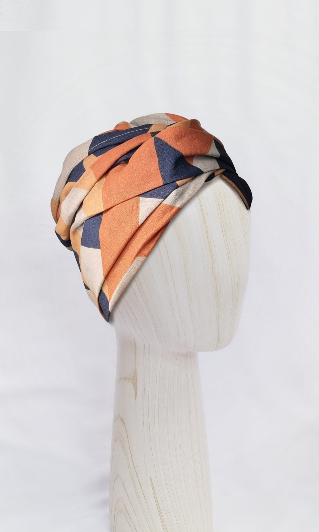 Celine Martine Josephine in Geo Nautic print. Head wrap in breathable cotton-linen. Showcasing versatile styles using the extra-length option in a modern orange and dusty blue geometric print.