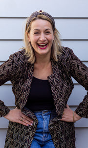 Portrait of Marion Lecesne wearing "Wonderwoman" headband, laughing at he camera