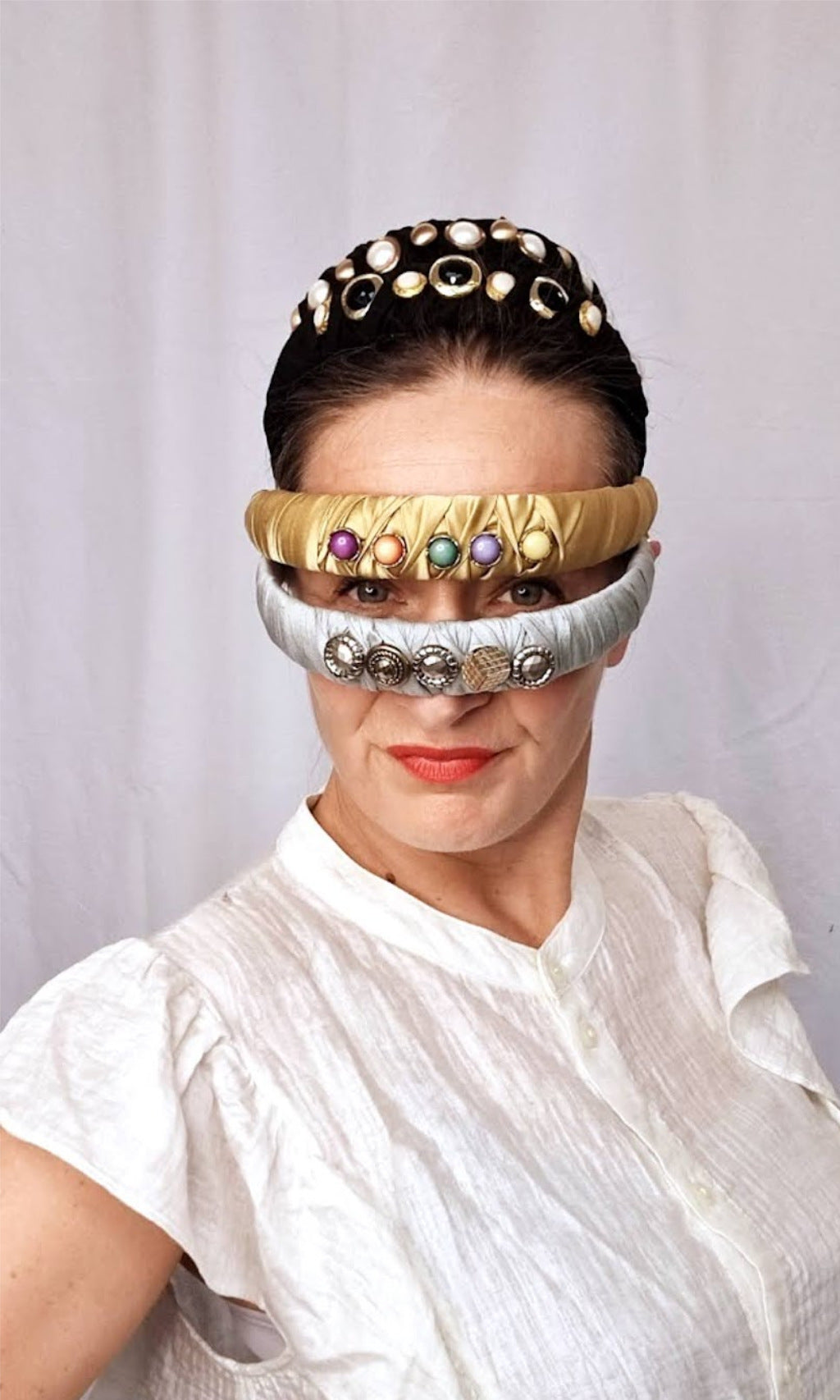 Collection of Meet Cute As A Button headbands in various colors worn by a woman, offering a fashionable and gentle alternative for women with sensitive scalps