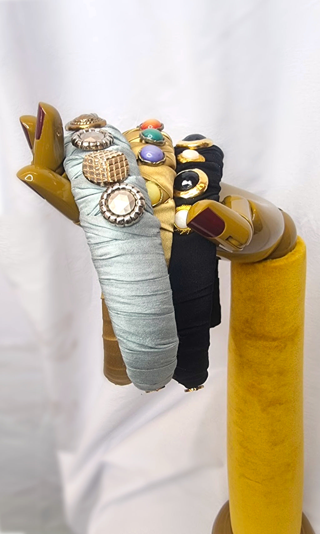 Hand-held collection and close-up view of vintage buttons used in Céline Martine’s signature Meet Cute As A Button headbands, blending style with comfort