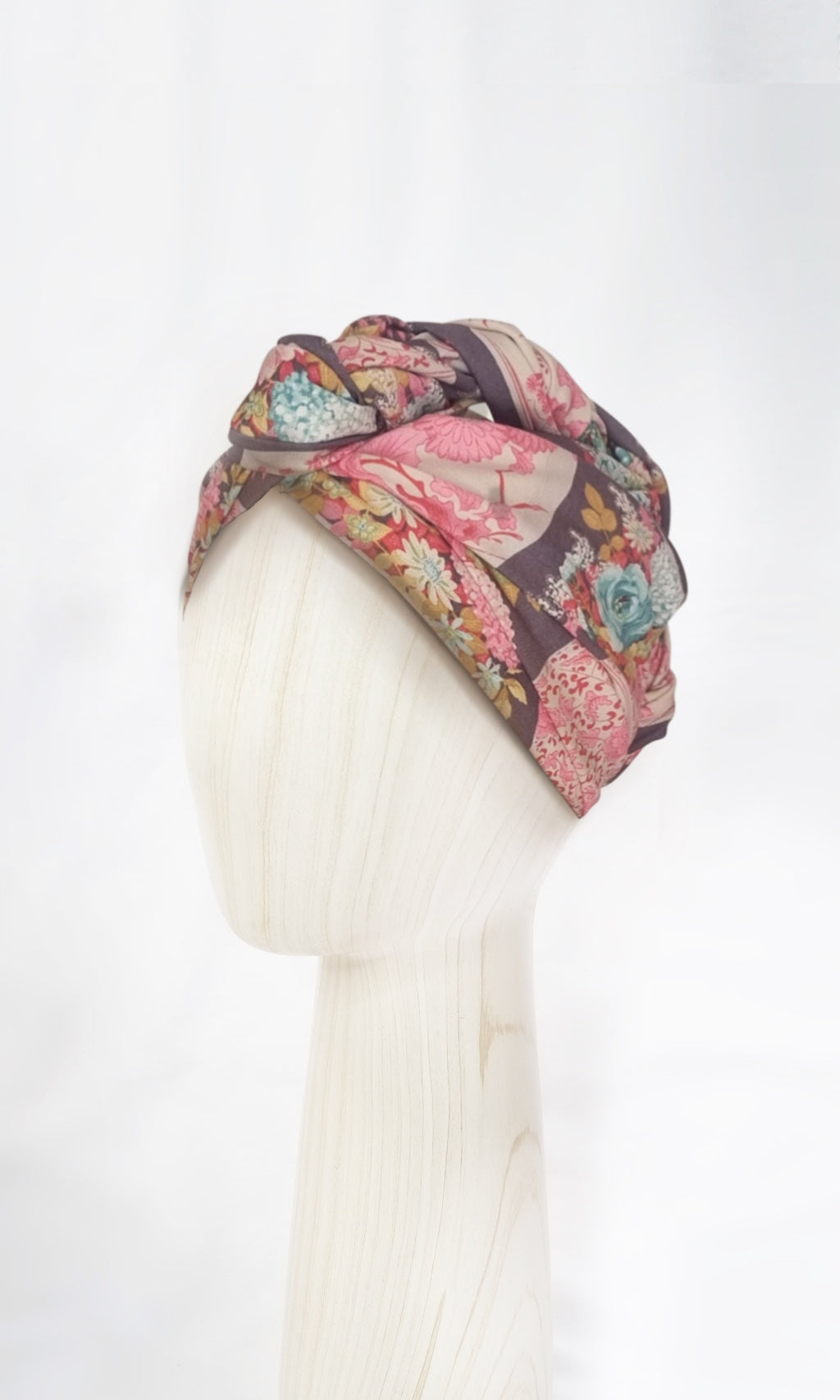 The Celine Martine wired head wrap in Flowervae grey displayed on a mannequin head styled in one of several hair scarf options