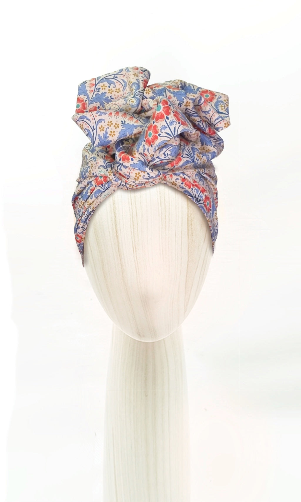 The Celine Martine wired head wrap in Elanora Blue displayed on a mannequin head styled in one of several hair scarf options