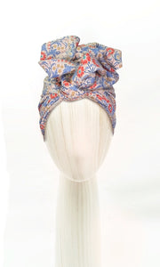 The Celine Martine wired head wrap in Elanora Blue displayed on a mannequin head styled in one of several hair scarf options