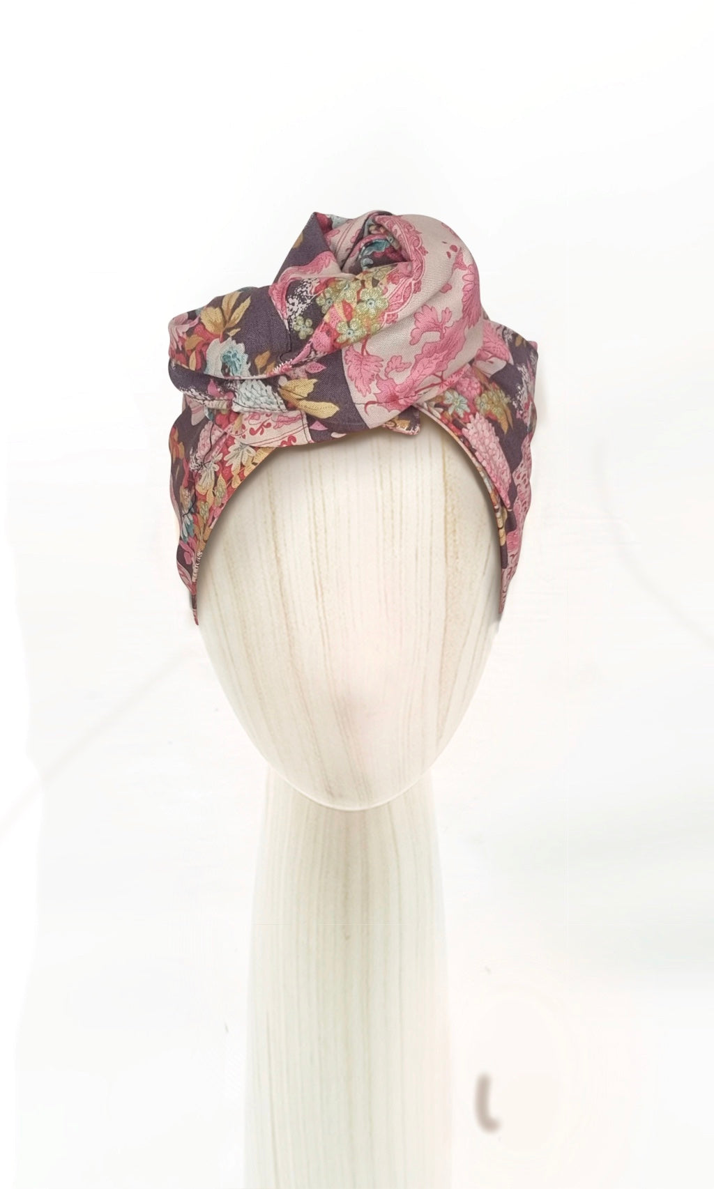 The Celine Martine wired head wrap in Flowervae grey displayed on a mannequin head styled in one of several hair scarf options