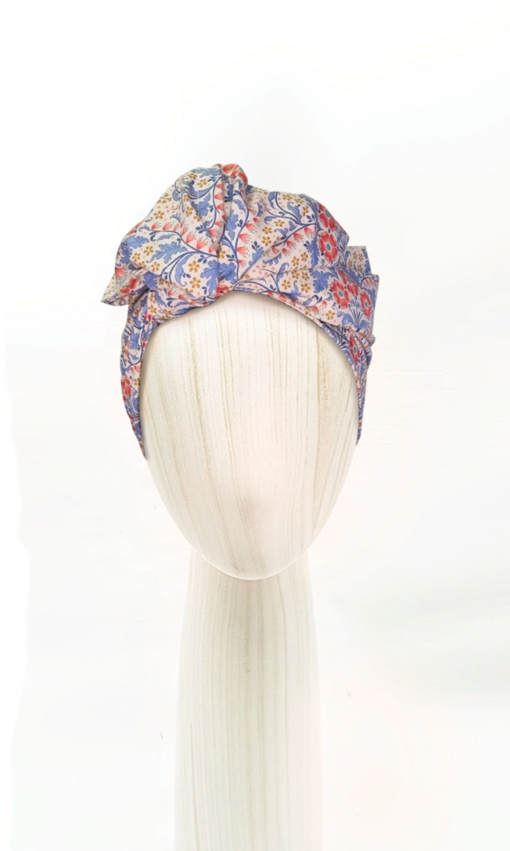 The Celine Martine wired head wrap in Elanora Blue displayed on a mannequin head styled in one of several hair scarf options
