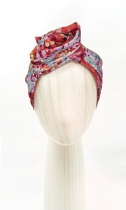 The Celine Martine wired head wrap in whimsyflower rust displayed on a mannequin head styled in one of several hair scarf options